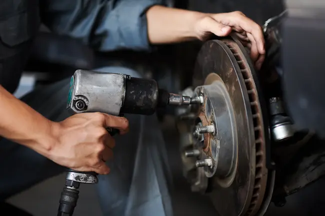 An engineer performing a tire rotation.